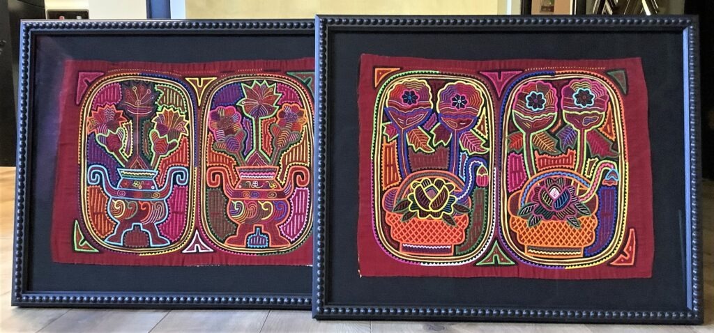 image of two red Panamanian Molas separately framed in black frames